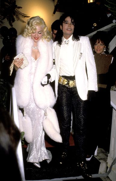 Madonna wearing a white dress with fur throw
