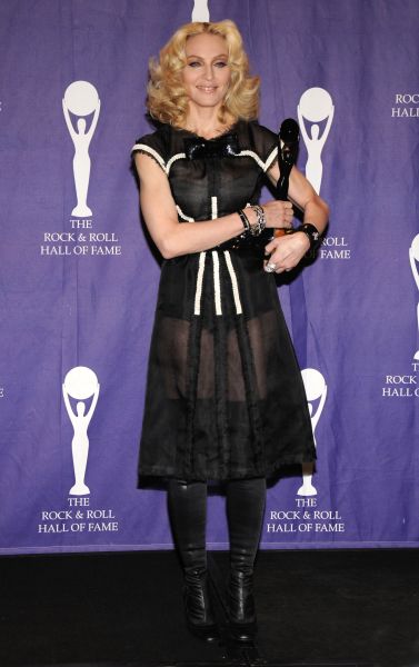 Madonna wearing a black sheer dress with white details