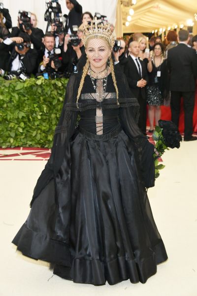 Madonna wearing a black gown with braids