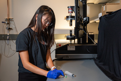 Rice University graduate student Faye Yap with a deceased wolf spider for use as a necrobotic gripper. (Credit: Brandon Martin/Rice University)