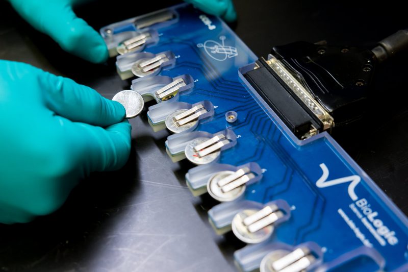 A scientist tests batteries in a lab