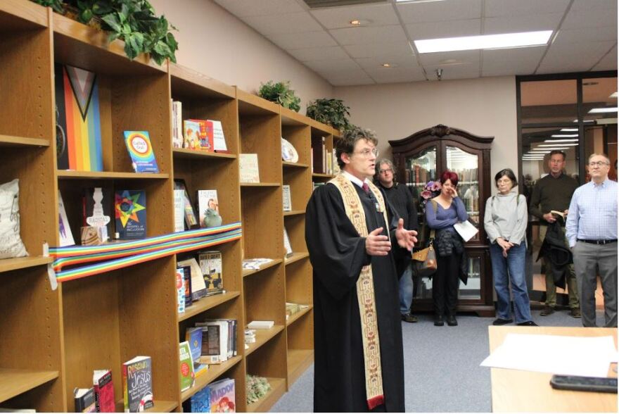 The Rev. Ryon Price, senior pastor of Broadway Baptist Church, speaks at the ribbon-cutting ceremony Feb. 11, 2024, about one of the books added to the library’s new LGBTQ+ shelf. “We believe that it was actually one of the books that was a matter of contention in another community and the fact that it’s now at a Baptist church in Texas, I think can only be a godsend,” Price said.