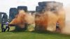 Environmental protesters spray 'orange powder paint' on Britain's Stonehenge